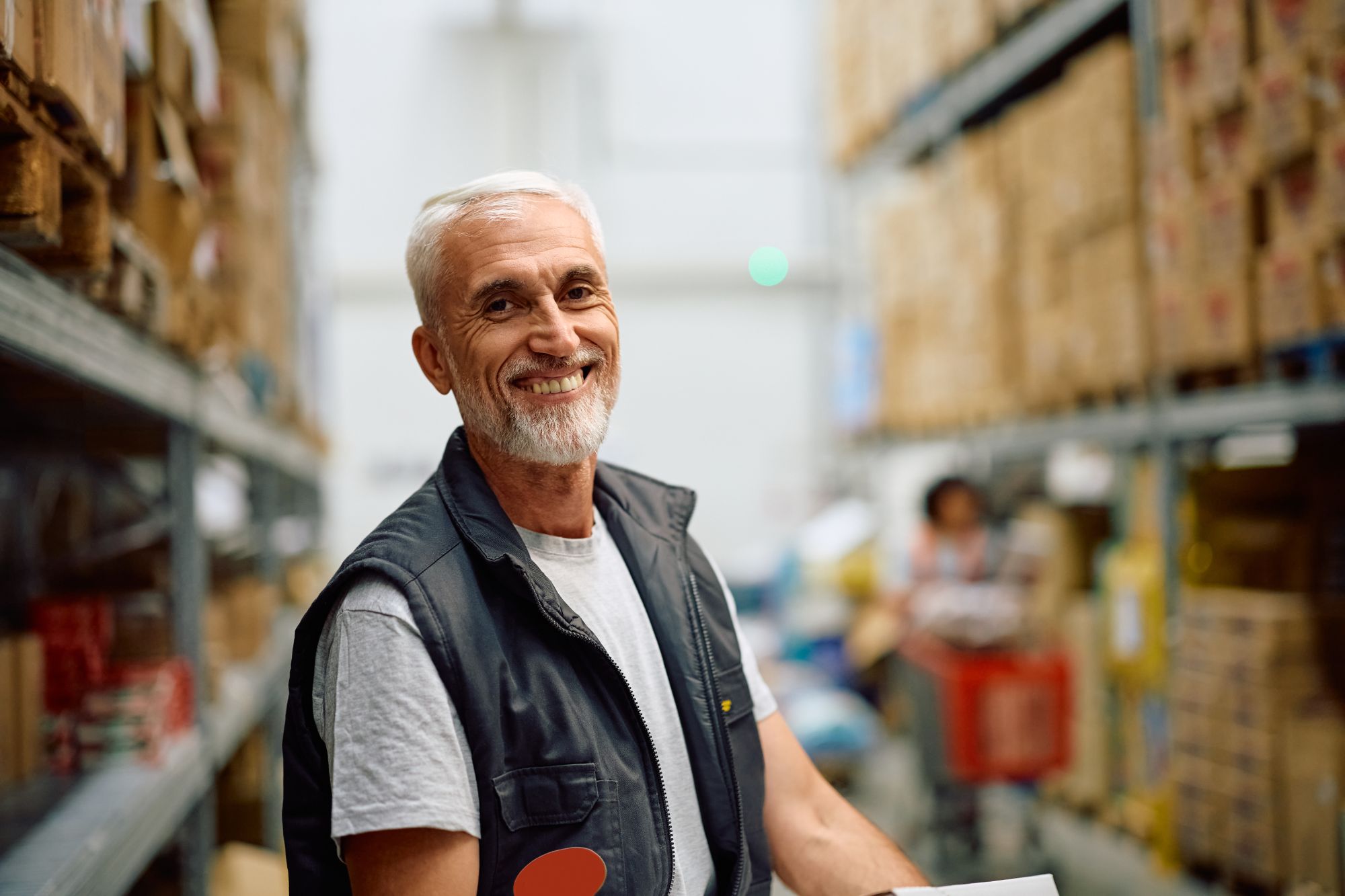 Happy warehouse worker looking confident
