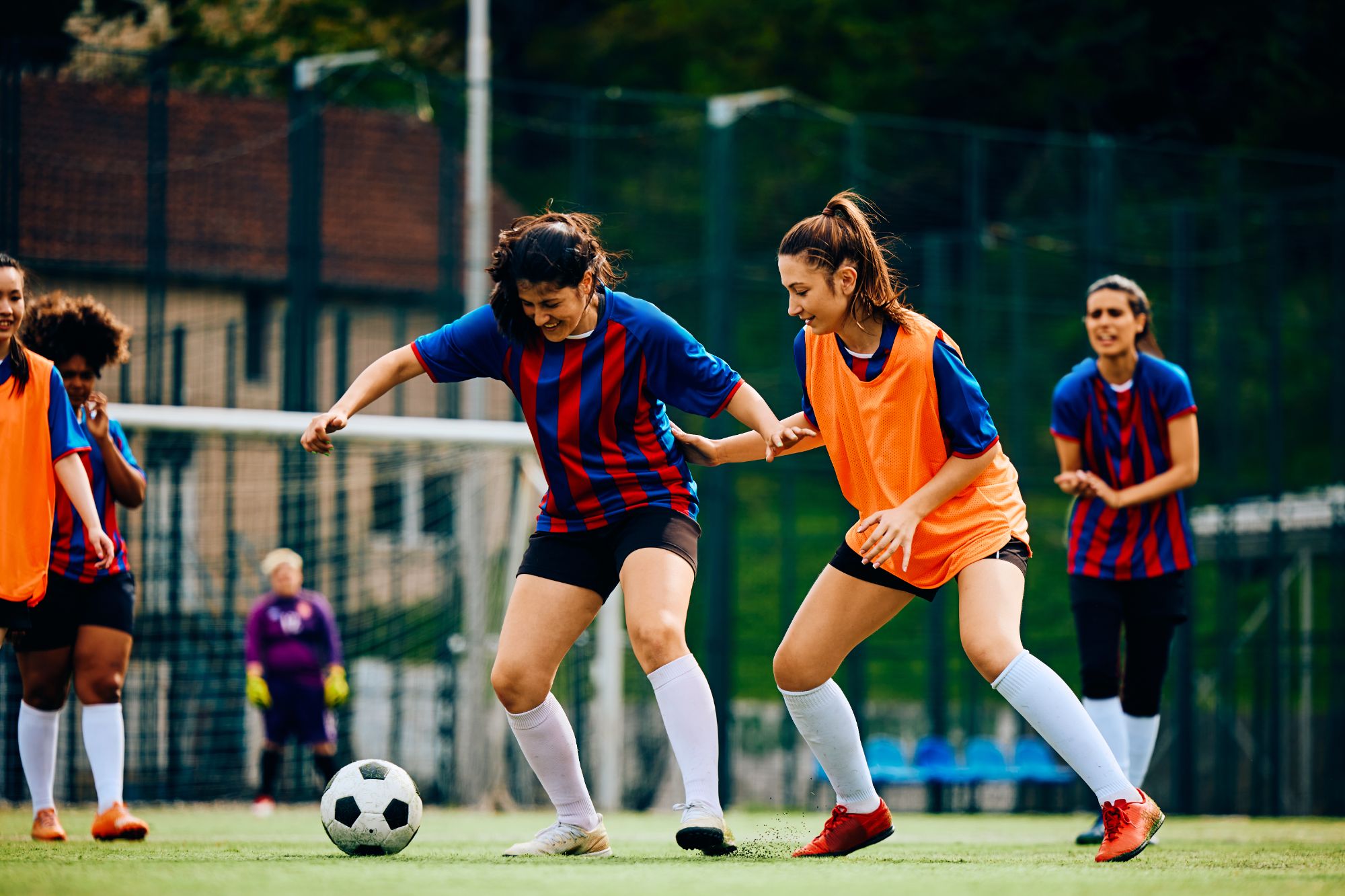 Women playing football on a sunny day